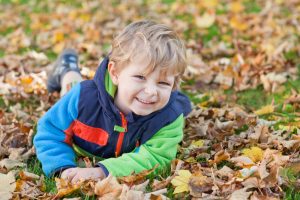 A child playing in leaves