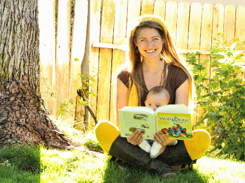 A woman holds a reading book for her baby
