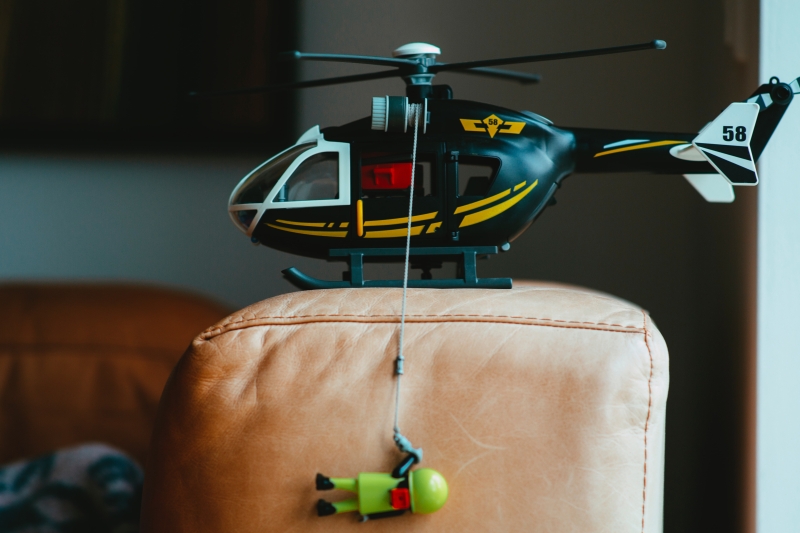 A helicopter with a toy figure dangling below